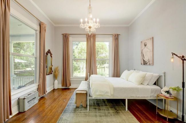 Bedroom featuring wood finished floors, a chandelier, and crown molding | Image 17