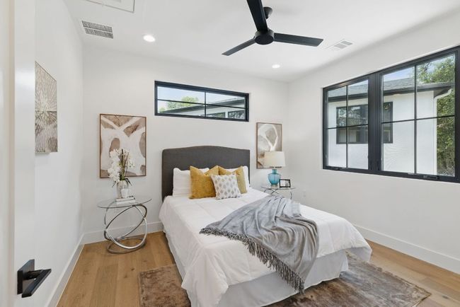 Bedroom featuring light wood-style floors, baseboards, recessed lighting, and ceiling fan | Image 25