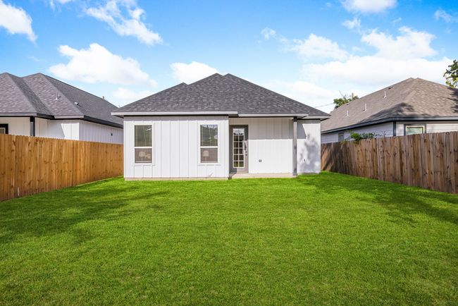 Back of property featuring a yard, a fenced backyard, and roof with shingles | Image 25