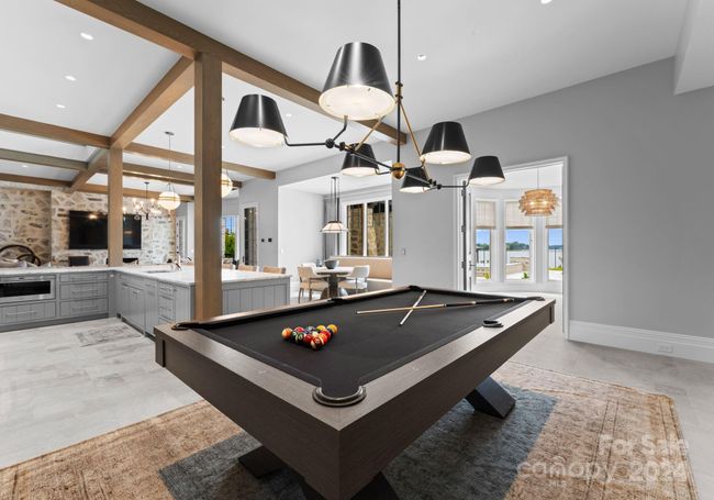 The billiard space is perfectly placed for entertaining in the open concept basement. | Image 34