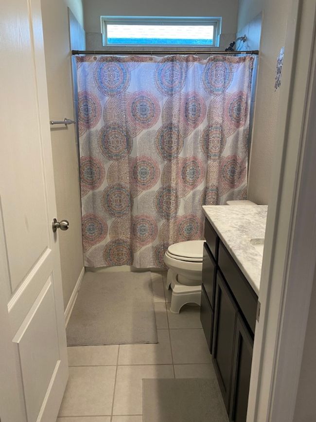 Bathroom featuring toilet, plenty of natural light, tile patterned flooring, and vanity | Image 11