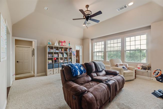 Living area featuring carpet flooring, ceiling fan, vaulted ceiling, and recessed lighting | Image 17