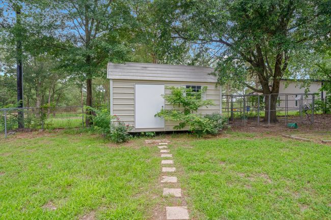 Fenced backyard with a storage unit | Image 30