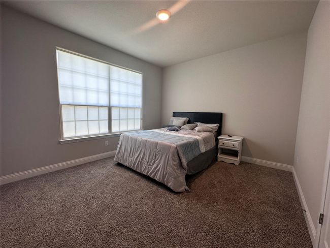Carpeted bedroom with baseboards | Image 11