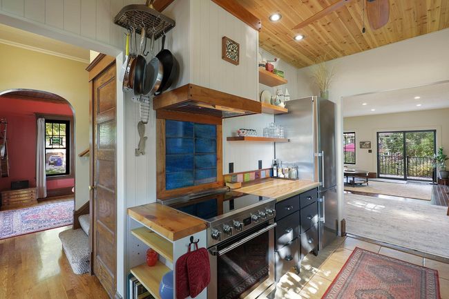 The recently updated Euro-style kitchen is open to both the living room and family room, f looded with light from the picture window overlooking a shade garden and the lake. | Image 10