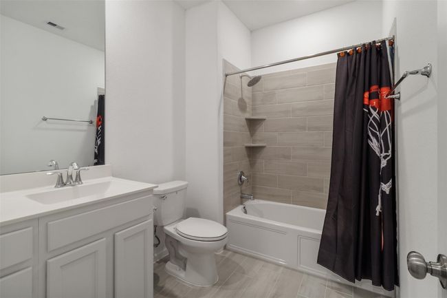 The hall bath is positioned just outside of the front two bedrooms. | Image 8