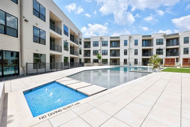 Community pool with a patio area and a hot tub | Image 24