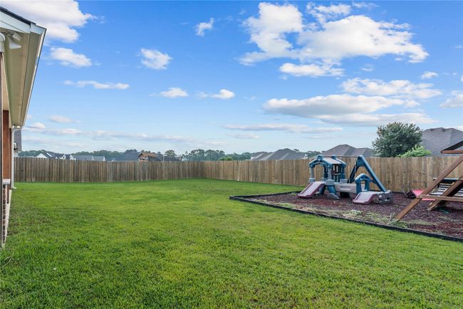 Fenced backyard featuring a playground | Image 26