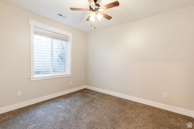 Spare room with dark carpet and ceiling fan | Image 36