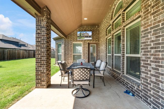 Fenced backyard with a patio and outdoor dining area | Image 35