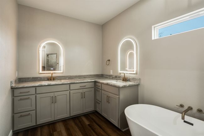 Full bath with a soaking tub, wood finished floors, a sink, and double vanity | Image 14
