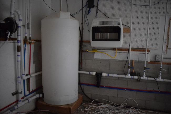 Utility shop/garage featuring heating unit and gas water heater | Image 85