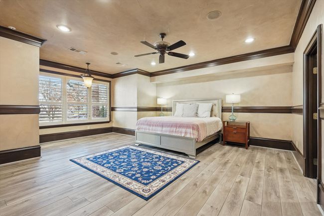 Bottom floor guest room with en suite bath could be a second primary and has a door directly out to the pool as well as an adjacent sitting room. | Image 31