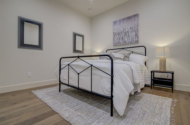 Bedroom with baseboards and wood finished floors | Image 18