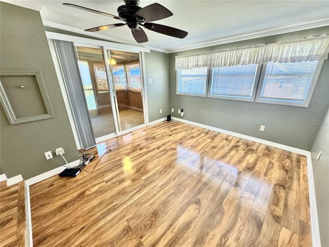 View of living room to rear screened in porch | Image 10
