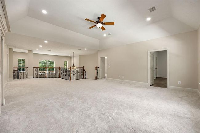 Upstairs, you'll find a spacious game room, four bedrooms, and a media room, all with access to a balcony that overlooks the pool and spa. | Image 28