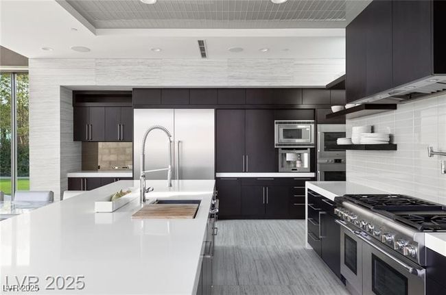 Kitchen with light countertops, modern cabinets, and built in appliances | Image 20