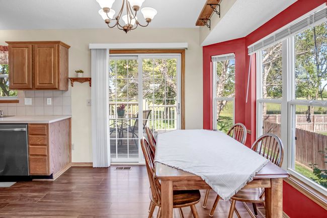 Dining room with a chandelier and dark wood-type flooring | Image 8