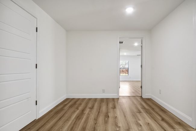 Empty room with light wood-style floors, recessed lighting, visible vents, and baseboards | Image 12