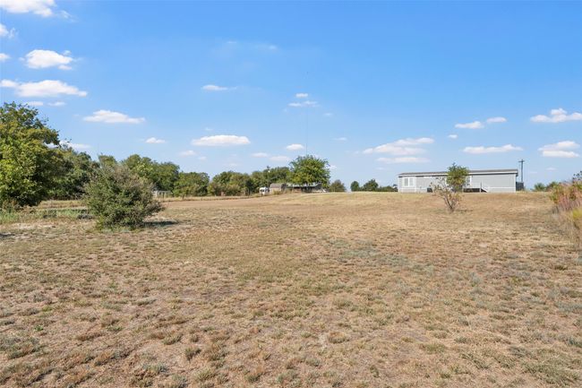 View of green lawn with a view of countryside | Image 29