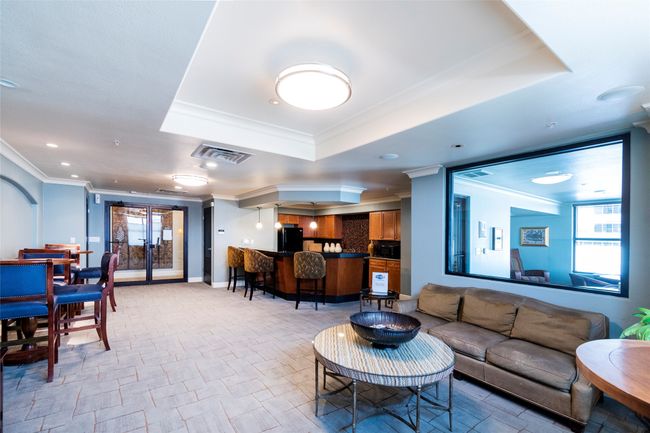 Living area with visible vents, baseboards, a tray ceiling, and ornamental molding | Image 34