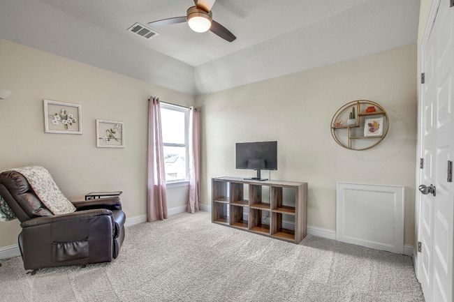 Living area with ceiling fan, carpet floors, and lofted ceiling | Image 34