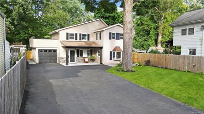 View of property featuring a garage and a front yard | Image 3