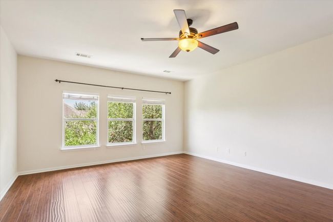 Unfurnished room featuring wood finished floors and a ceiling fan | Image 18