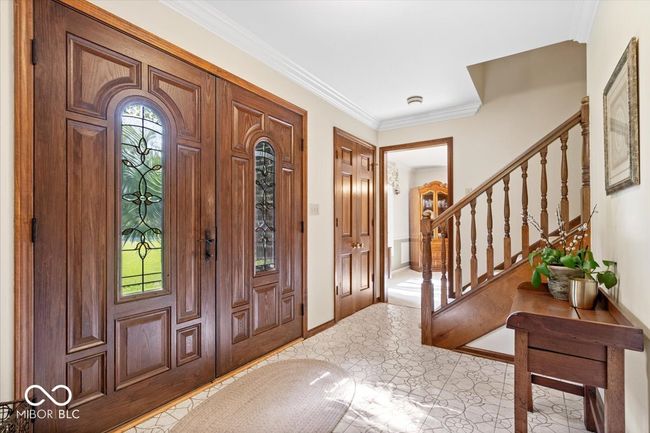entrance foyer with stairs and crown molding | Image 4