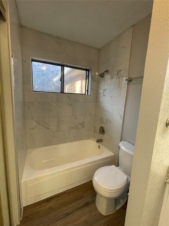 Full bathroom featuring wood finished floors and shower combination | Image 22