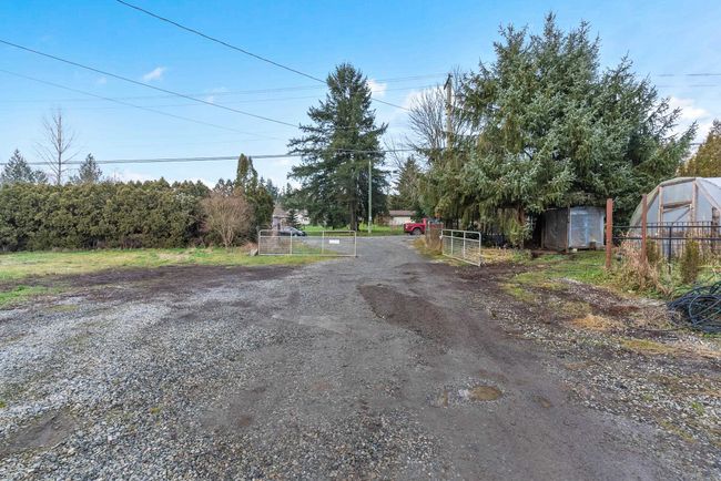 View of street featuring a gated entry and driveway | Image 8