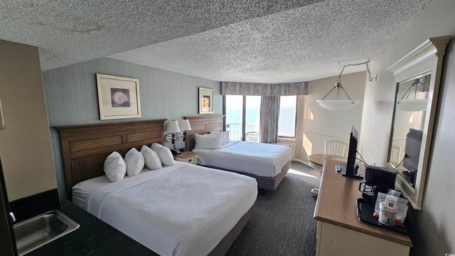 Carpeted bedroom with a textured ceiling | Image 7