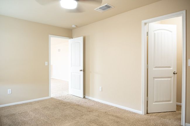 Unfurnished bedroom with carpet, baseboards, and ceiling fan | Image 24