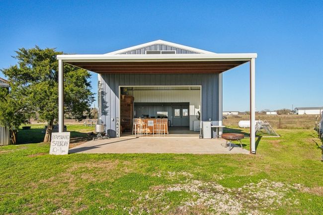 The commercial kitchen! With roll-up door, huge covered front porch, back covered porch too, half bathroom, and PLENTY of space for teaching and cooking up a storm. Insulated and mini split ductless AC. You could continue offering your farmstand here! Estimated 840 sq ft. | Image 15
