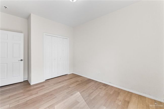 Unfurnished bedroom with light wood finished floors and a closet | Image 27
