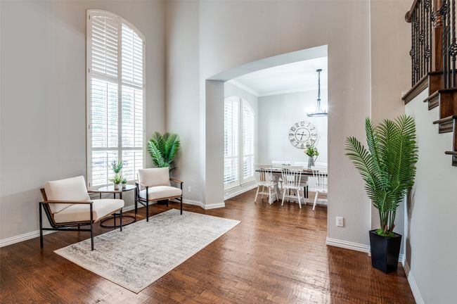 Sitting/Living room featuring crown molding, dark stained hand scraped hardwood finished floors, stairs, and baseboards | Image 34