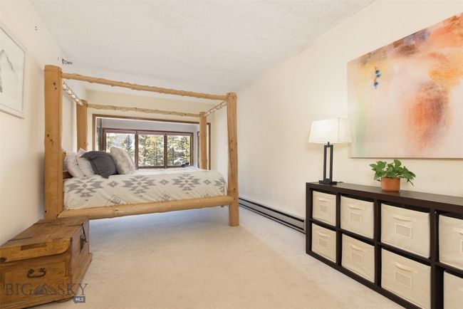 Bedroom with light carpet and a baseboard heating unit | Image 9