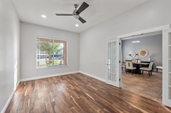 Huge home office includes french doors for privacy, as well as beautiful hardwood floors. | Image 15