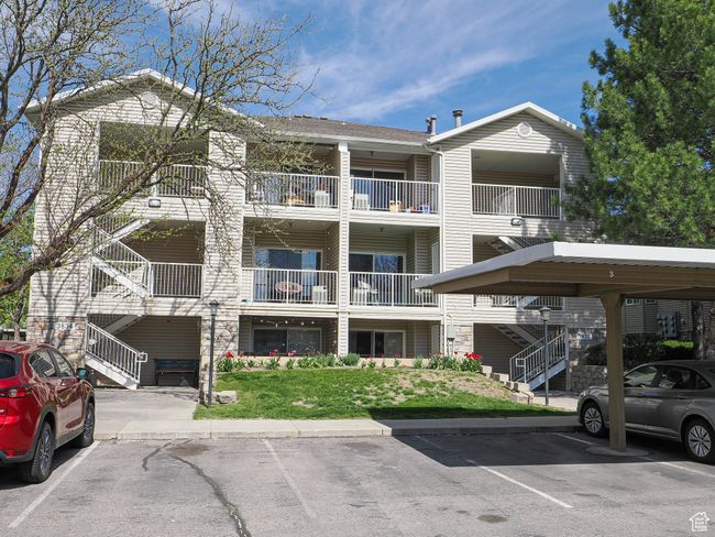 View of building exterior with covered and uncovered parking and stairs | Image 21