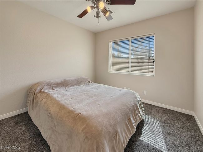 Carpeted bedroom featuring baseboards and a ceiling fan | Image 33