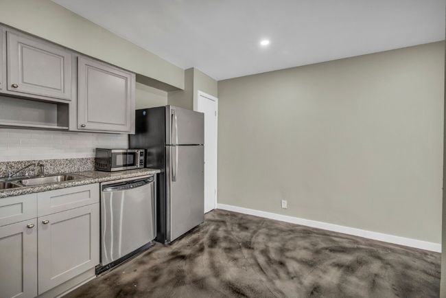 Kitchen featuring appliances with stainless steel finishes, decorative backsplash, a sink, baseboards, and recessed lighting | Image 5