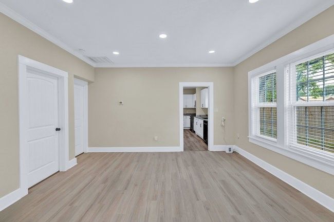 Unfurnished room featuring light wood-type flooring, crown molding, recessed lighting, and baseboards | Image 6