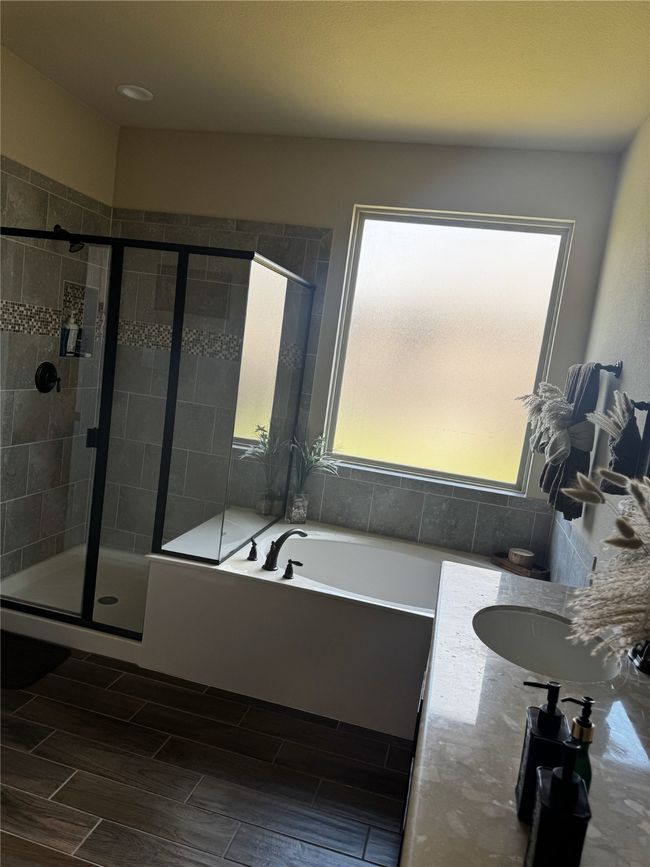 Master bath with plenty of natural light, a bath, a shower stall, and wood tiled floors | Image 8