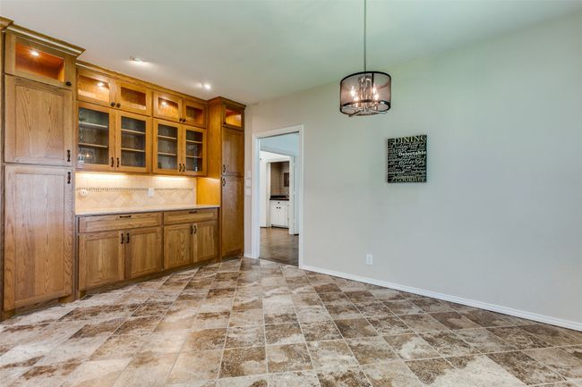 The glass front cabinets make this breakfast area into a place you can display your special serving dishes. The new Kichler light adds a touch of elegance. Under cabinet lighting compliments the lighted upper cabinets. | Image 9