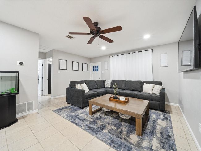 Living area featuring a ceiling fan, light tile patterned floors, recessed lighting, and baseboards | Image 5