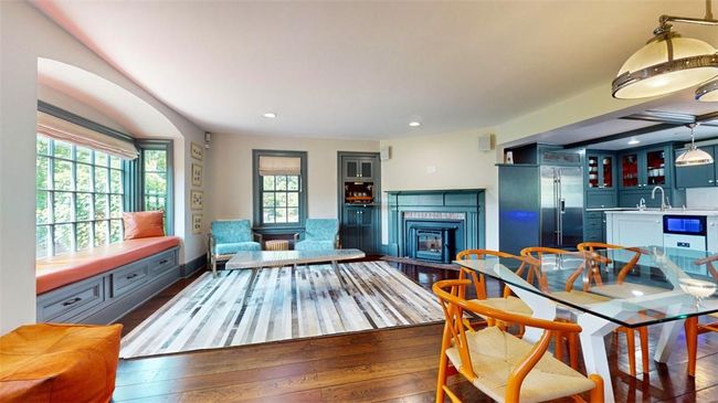 Family room with fireplace, built in bar, window seat, booth seating | Image 7