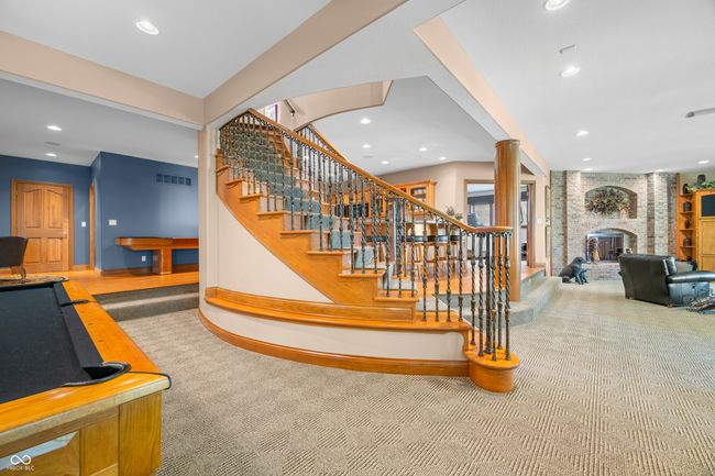 staircase featuring recessed lighting, a brick fireplace, visible vents, carpet, and baseboards | Image 59