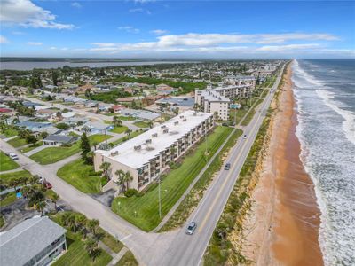 Aerial View of Building with Beach | Image 2