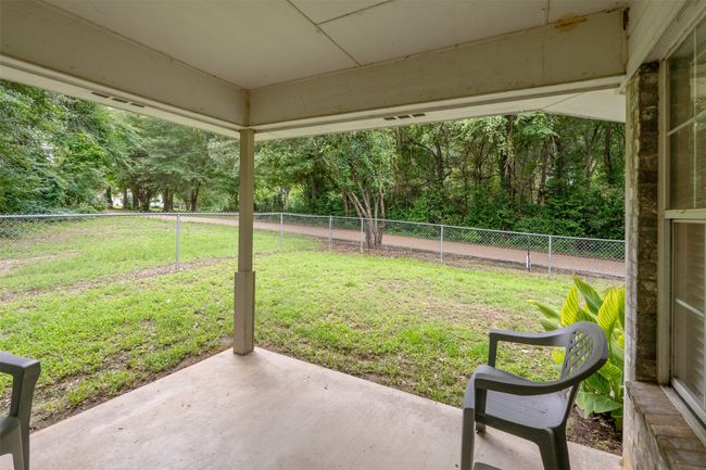 Fenced backyard featuring a patio area; extra space on the north side of the fenced-in backyard | Image 26