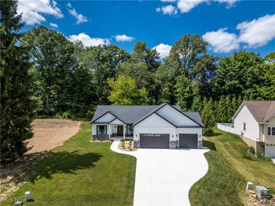 View of front of property featuring a front yard and a garage | Image 2